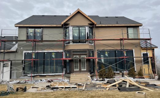 Structural framing in North Salt Lake UT converting small windows into large Pella tri-fold sliding doors.