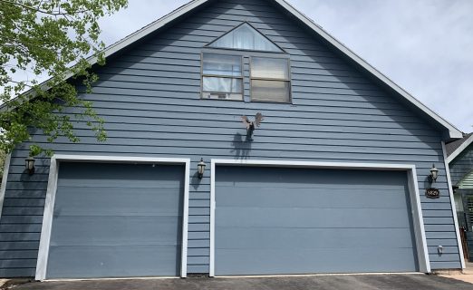 Jeremy Ranch UT garage loft with blue-grey siding before Christensen Exteriors forensic building envelope remodel.