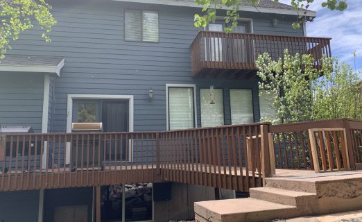 Failing wooden deck and blue-grey siding in Jeremy Ranch UT before forensic exterior remodel by Christensen Exteriors.