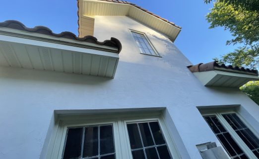 A worm's-eye view looking upward at new wood framing extending 16 inches from the original eave line of the house, preparing for new soffit and fascia.