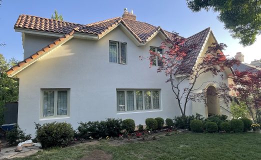 A clean photo of the completed terracotta roof on the SLC Avenues home, showing the rich orange-red tiled surface against a blue sky.