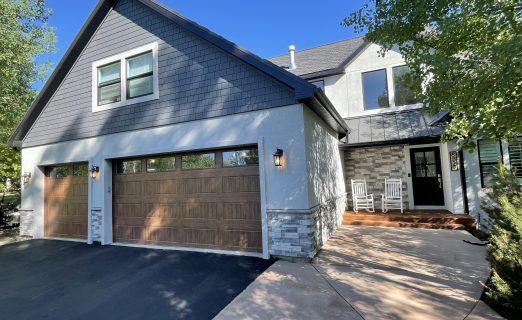 Full exterior remodel in Jeremy Ranch UT featuring Pella Windows, smooth EIFS stucco, Hardie board shingles, and custom stone wainscoting by Christensen Exteriors.