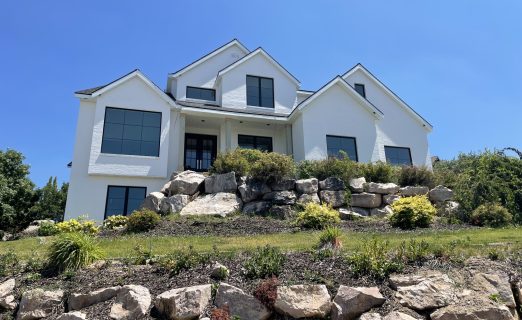 Modern white Senergy stucco with black Pella windows and black trim in North Salt Lake by Christensen Exteriors.